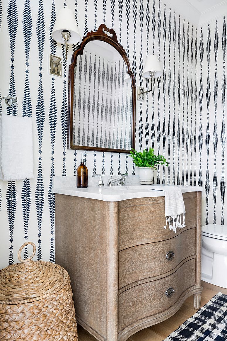 Accessories, wallpaper and lighting give this powder room a cool look