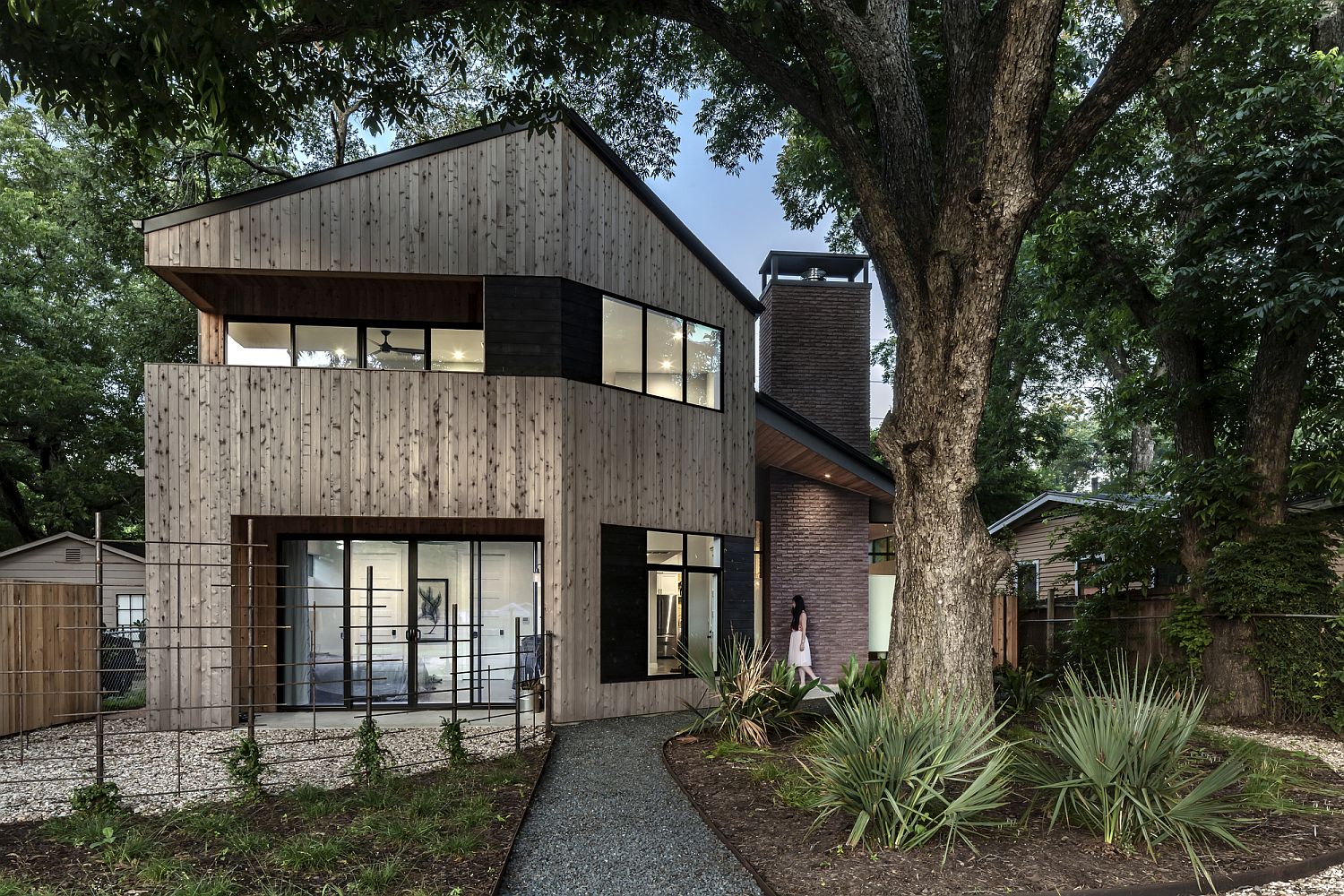 Beautiful cedar elm exterior of the Hewn House feels warm and inviting