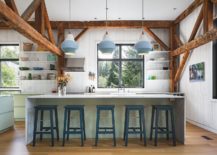 Beautiful-farmhouse-style-kitchen-with-floating-white-shelves-light-green-cabinets-and-blue-pendant-lights-217x155