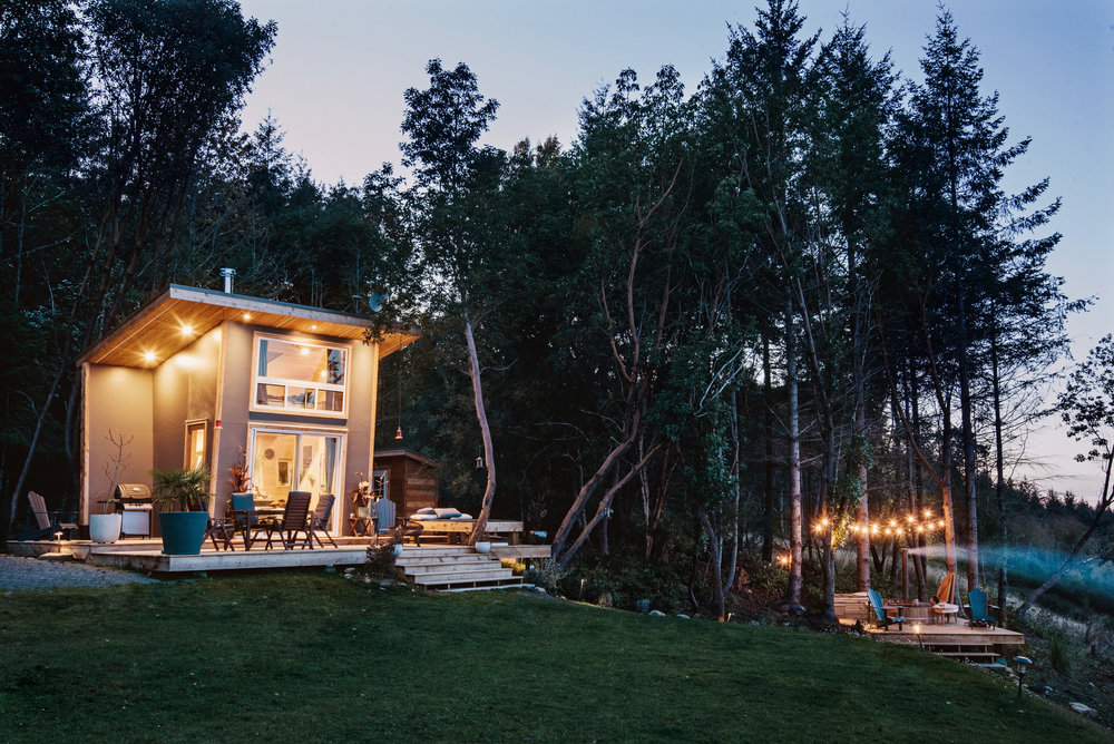 Beautiful lighting illuminates boththe cabin and gorgeous deck outside