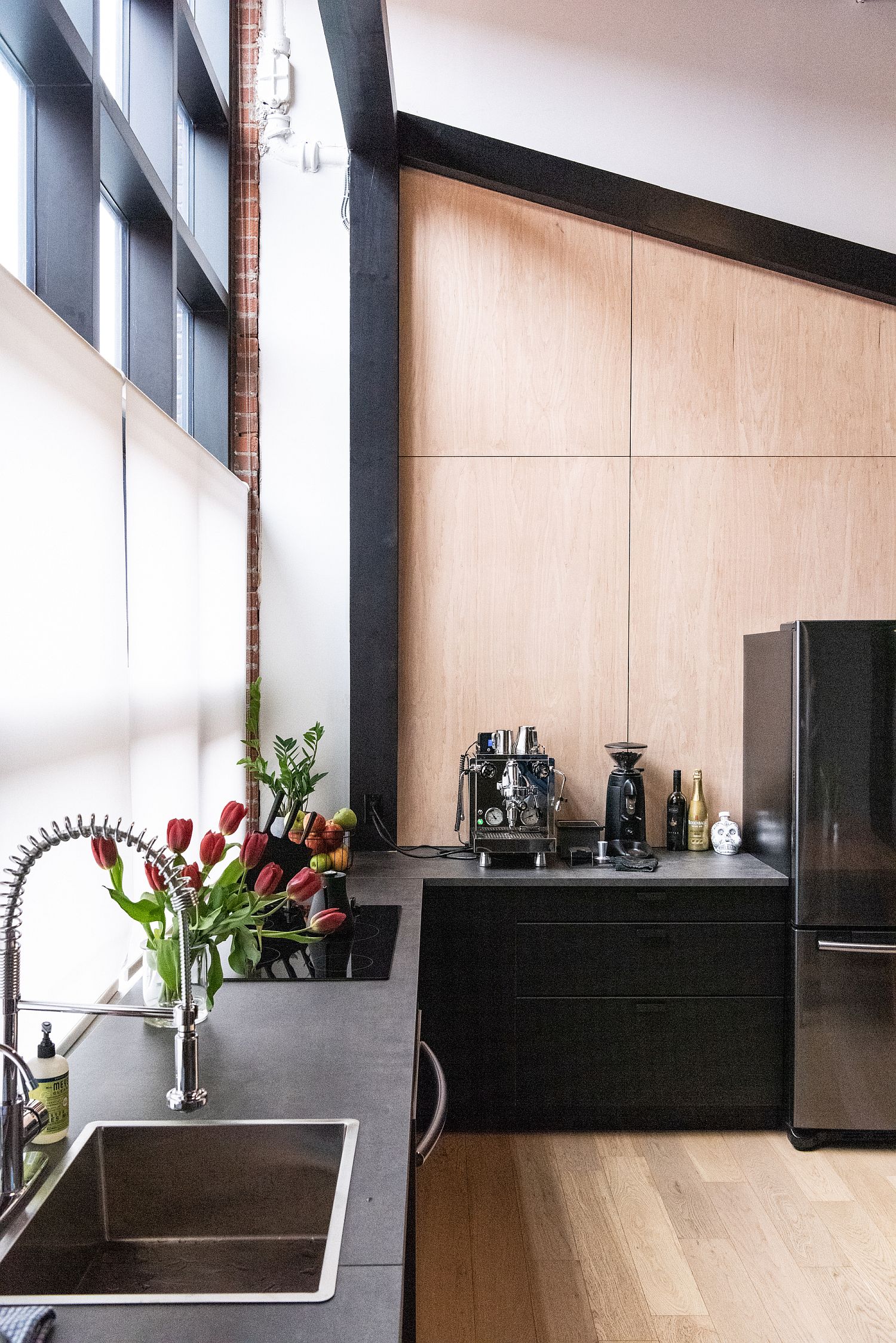 Beautiful wood and black kitchen with ample natural lighting