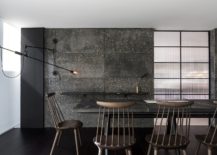 Dark-and-dashing-backdrop-of-the-dining-room-crafted-using-Tresunos-concrete-217x155