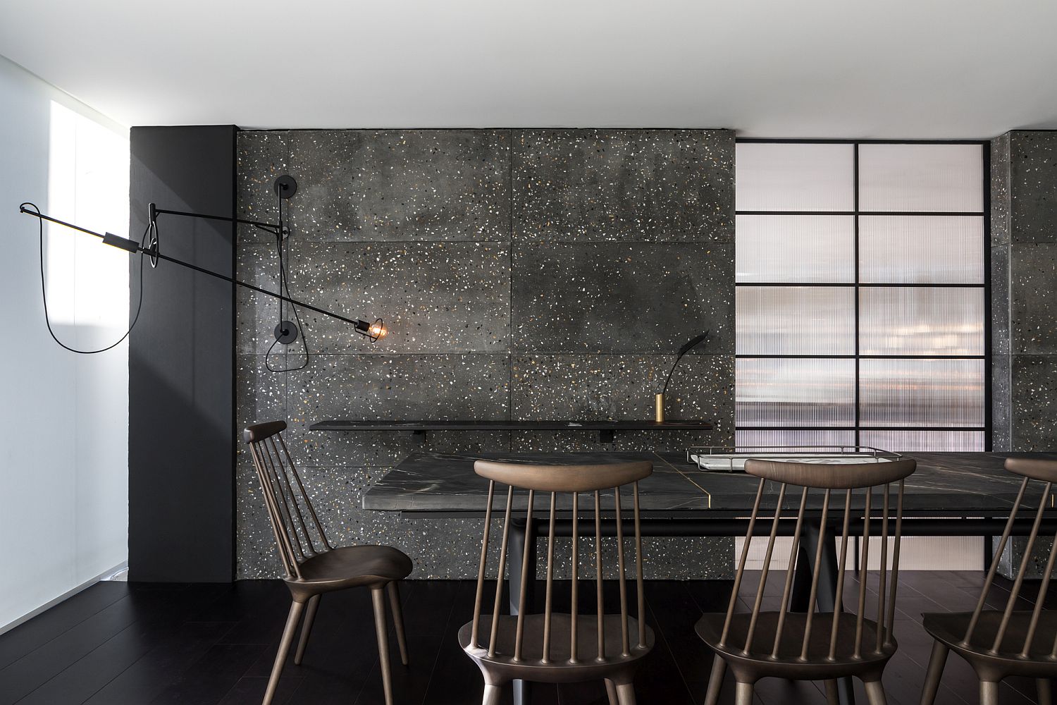 Dark and dashing backdrop of the dining room crafted using Tresuno's concrete