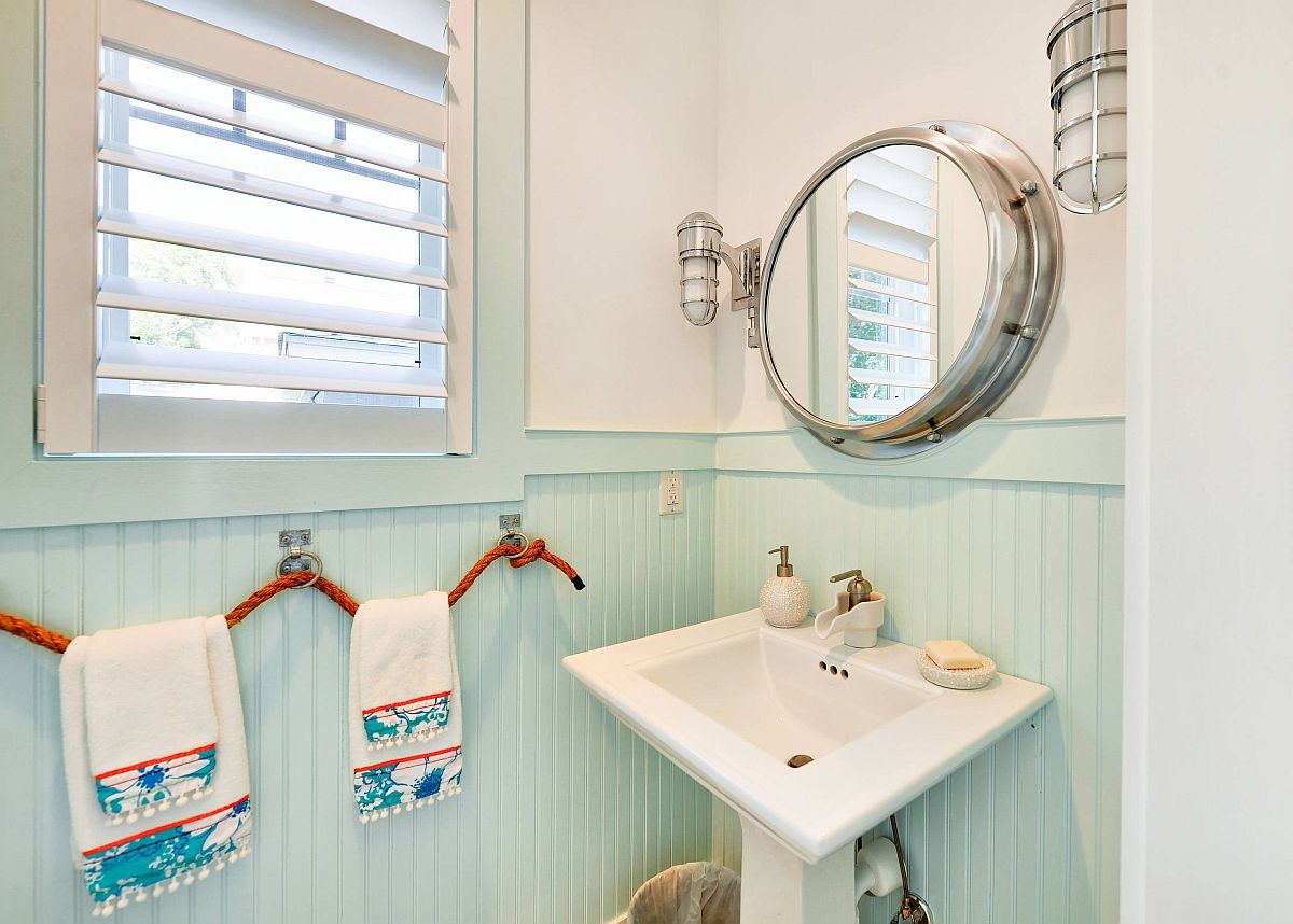 Light-blue-and-white-powder-room-with-beach-style-and-innovative-rope-towel-hangers