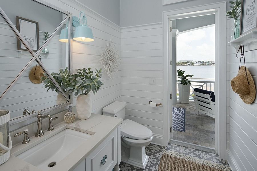 Light-filled and white powder room is connected with the outdoors beautifully