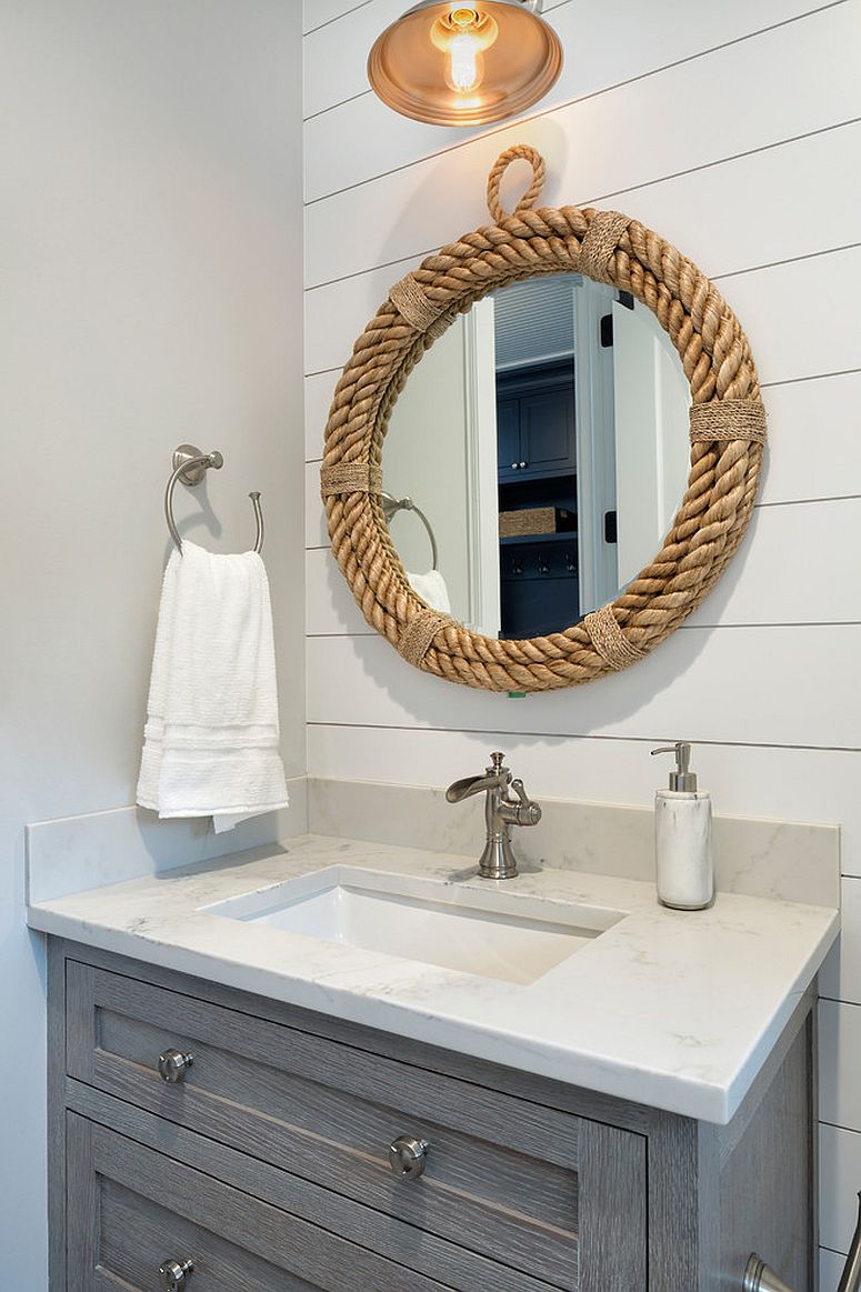 Mirror with rope frame accentuates the coastal appeal in this white powder room