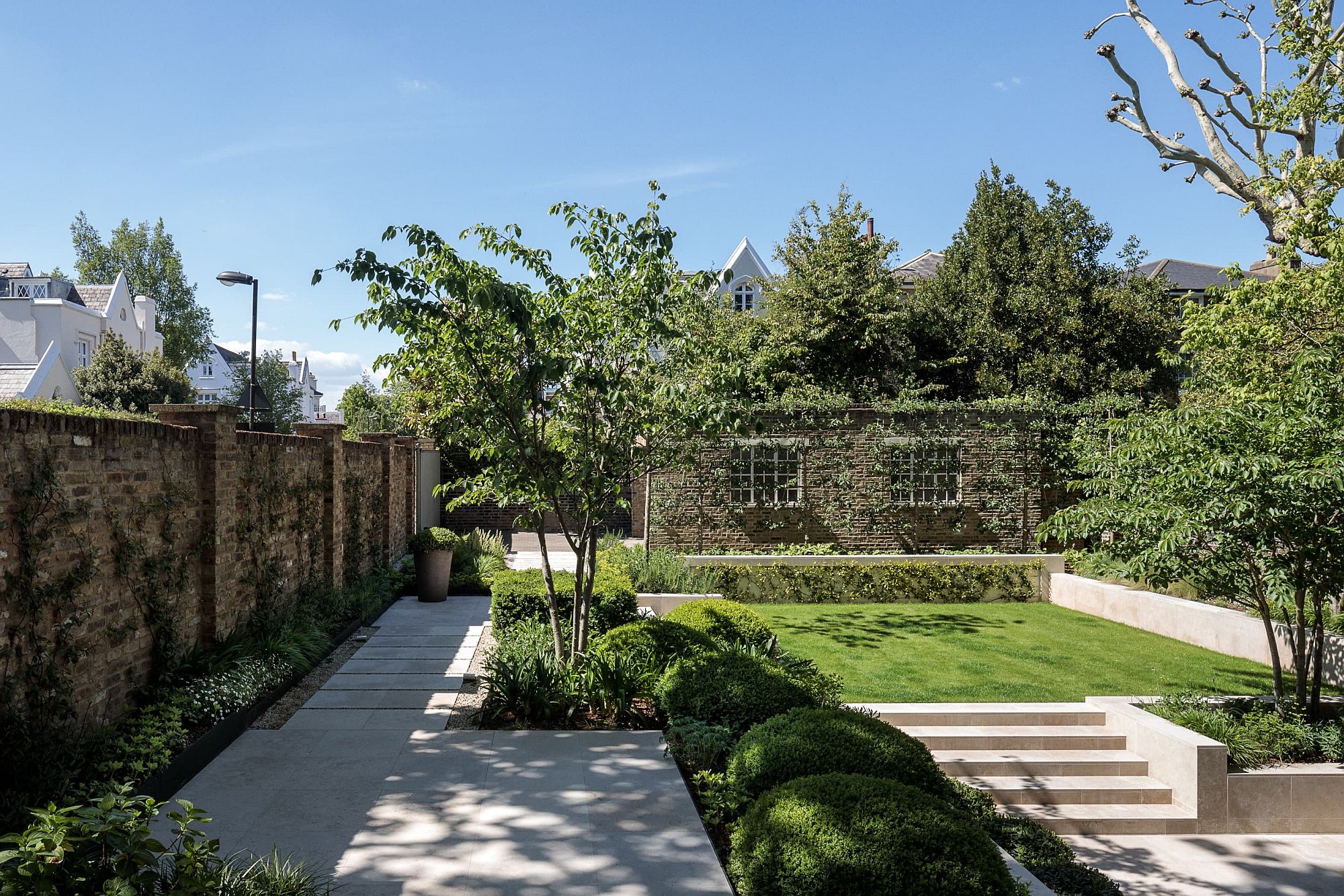 Multi-level gardens with a curated landscape add to the appeal of the house