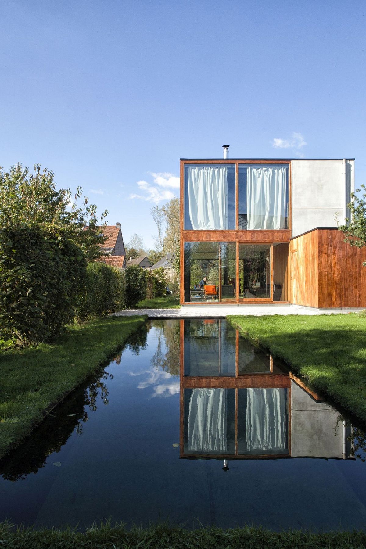 Reflective pool and garden around the house add to its relaxing appeal