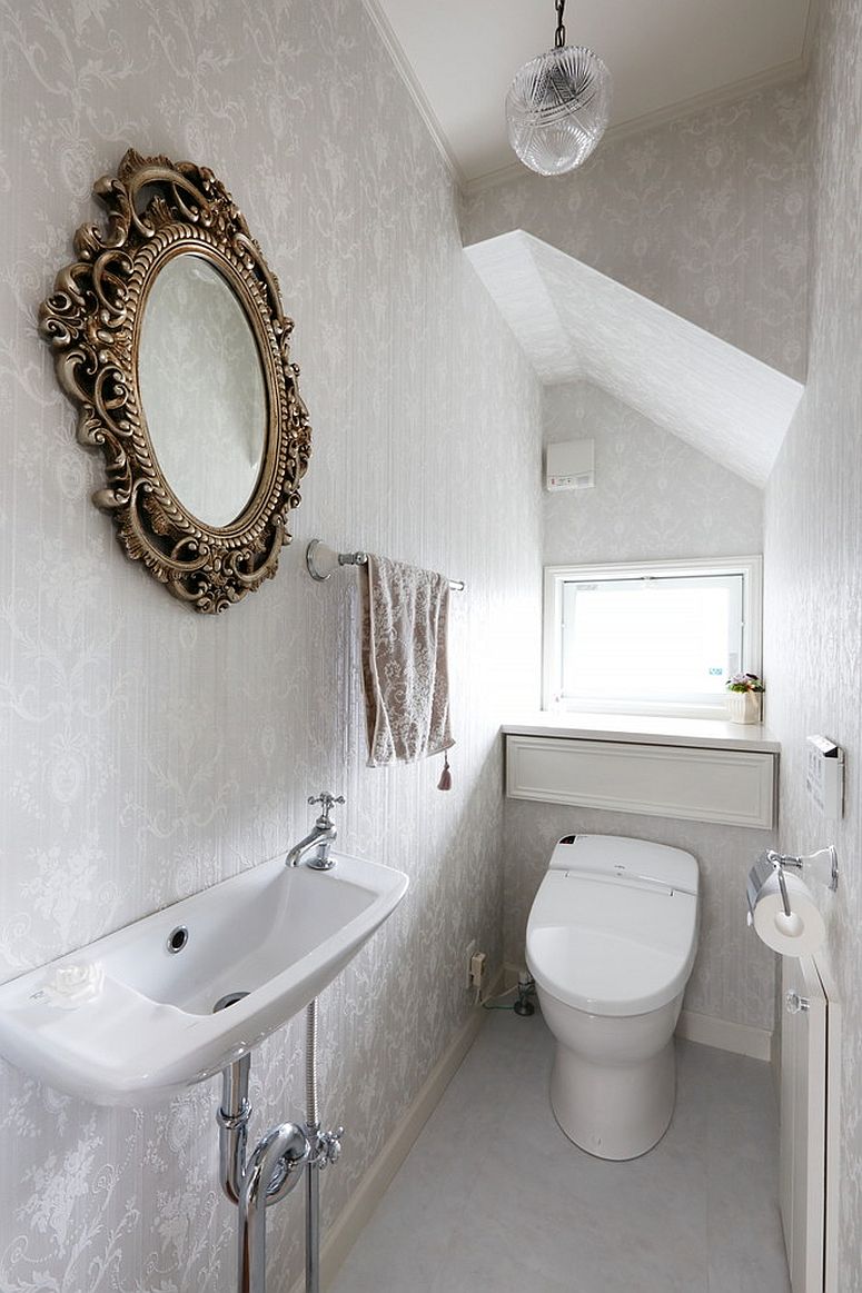 Silvery wallpaper gives the powder room a light and airy appeal