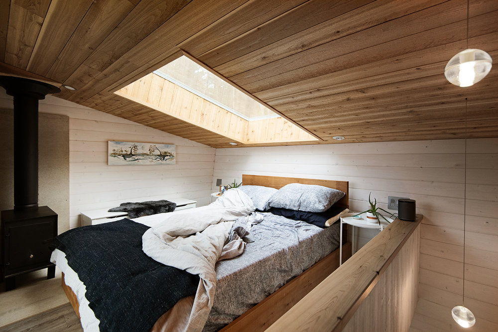 Skylight above the bedroom bed offers a window into the sky