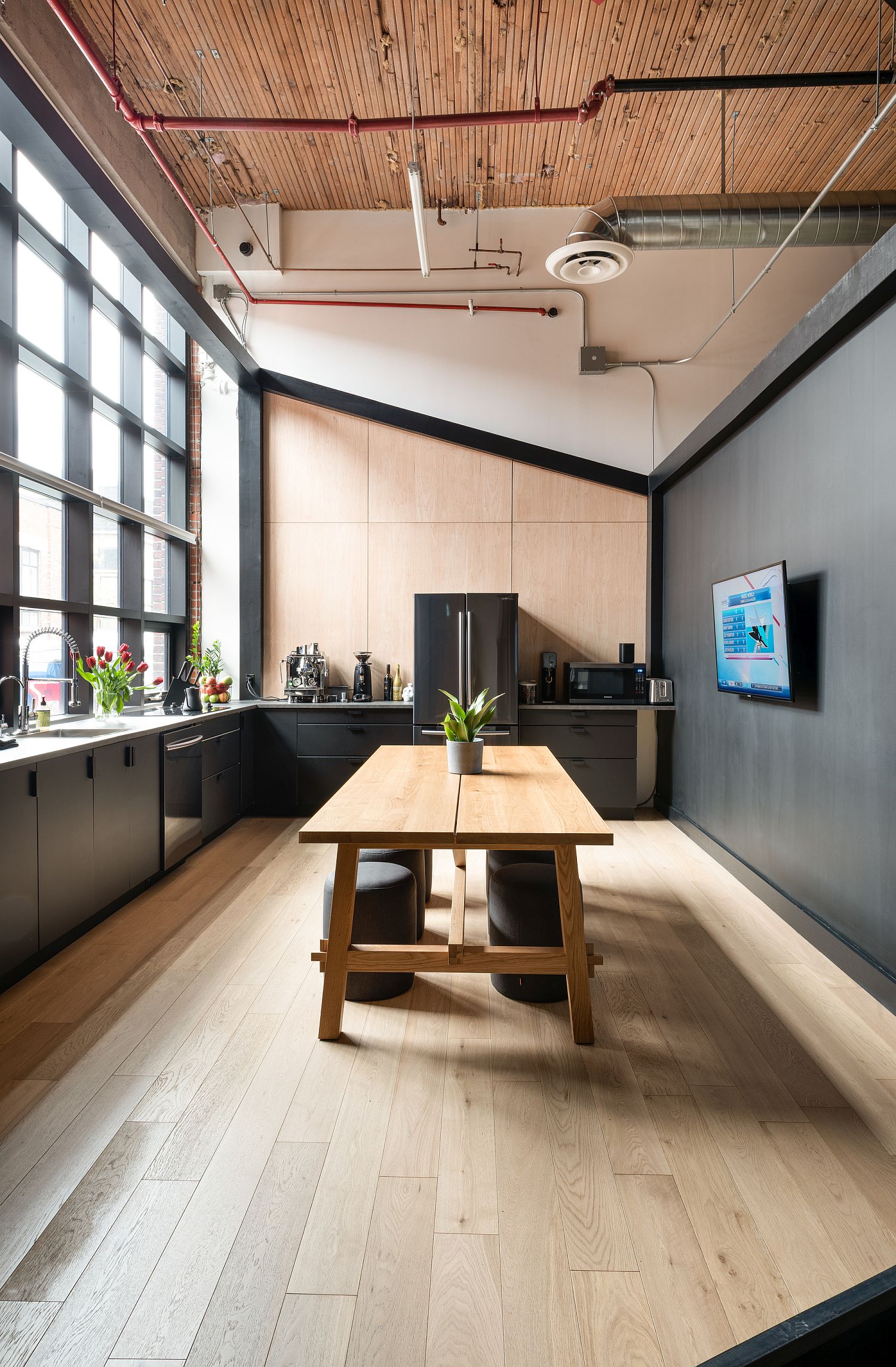 Spacious kitchen of the office with dark and dashing style