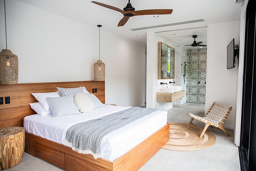 Tropical style bedroom in white with a bedframe and headboard in wood