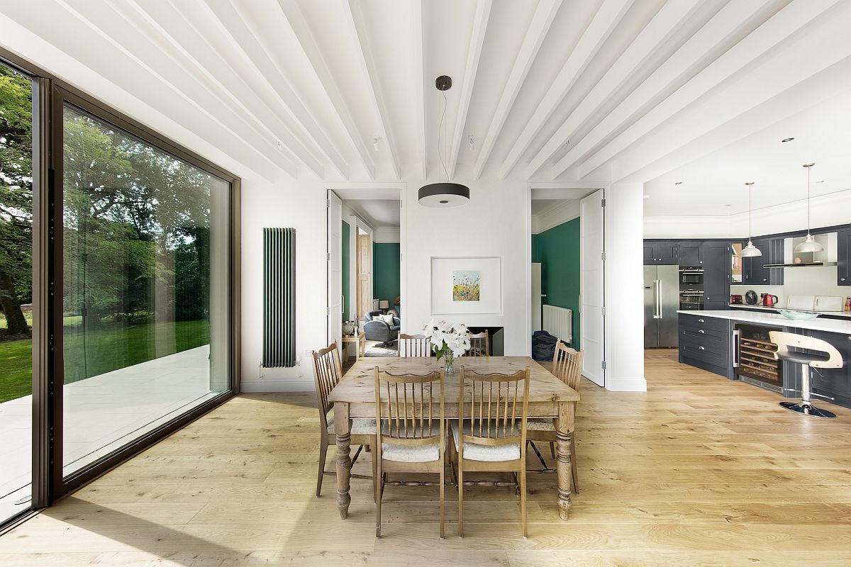 White-and-wood-dining-area-of-the-house-with-sliding-glass-doors-connecting-it-to-the-deck-outside