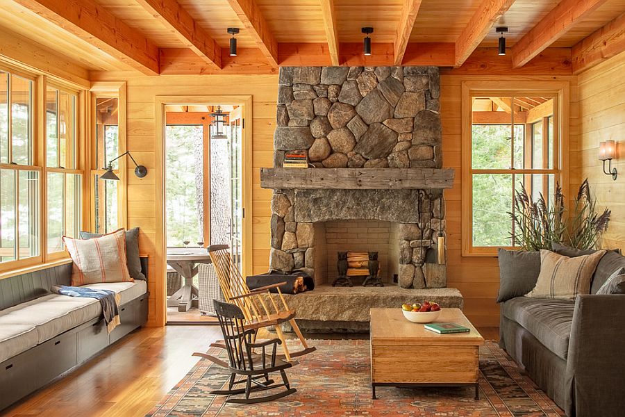 Wood-clad-living-room-with-comy-benches-and-a-stone-fireplace