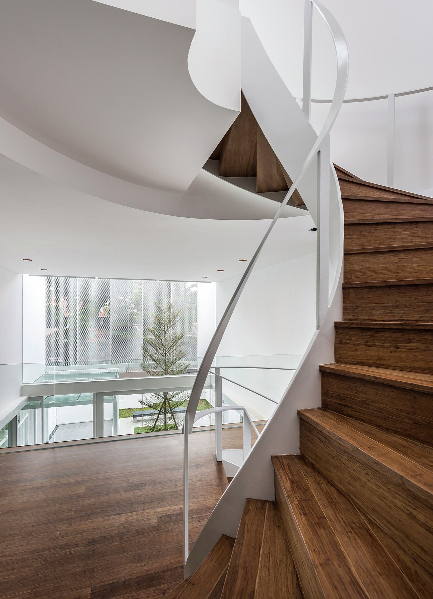 Awesome contemporary wooden staircase is the central focal point of the house