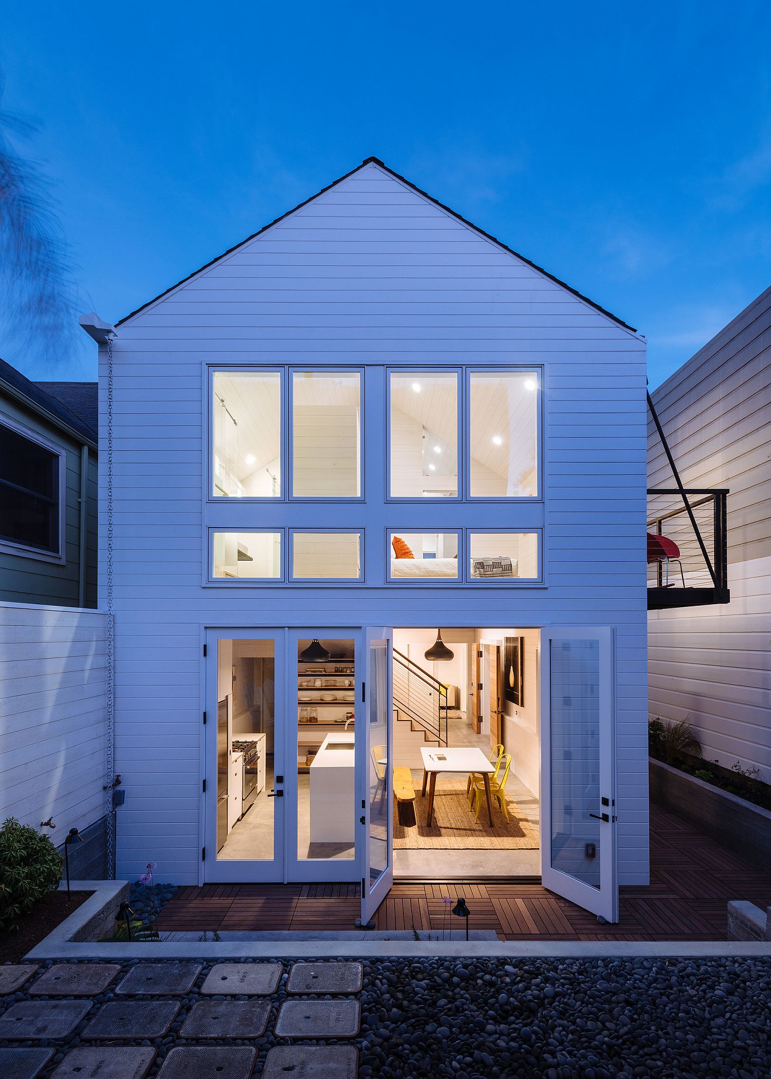 Beautiful rear facade of the extended home with a look at the kitchen, dining and the bedroom above