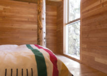 Bedroom-of-the-cabin-with-a-view-of-the-snowy-slopes-above-217x155