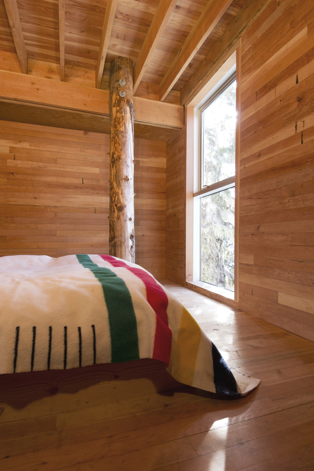 Bedroom of the cabin with a view of the snowy slopes above