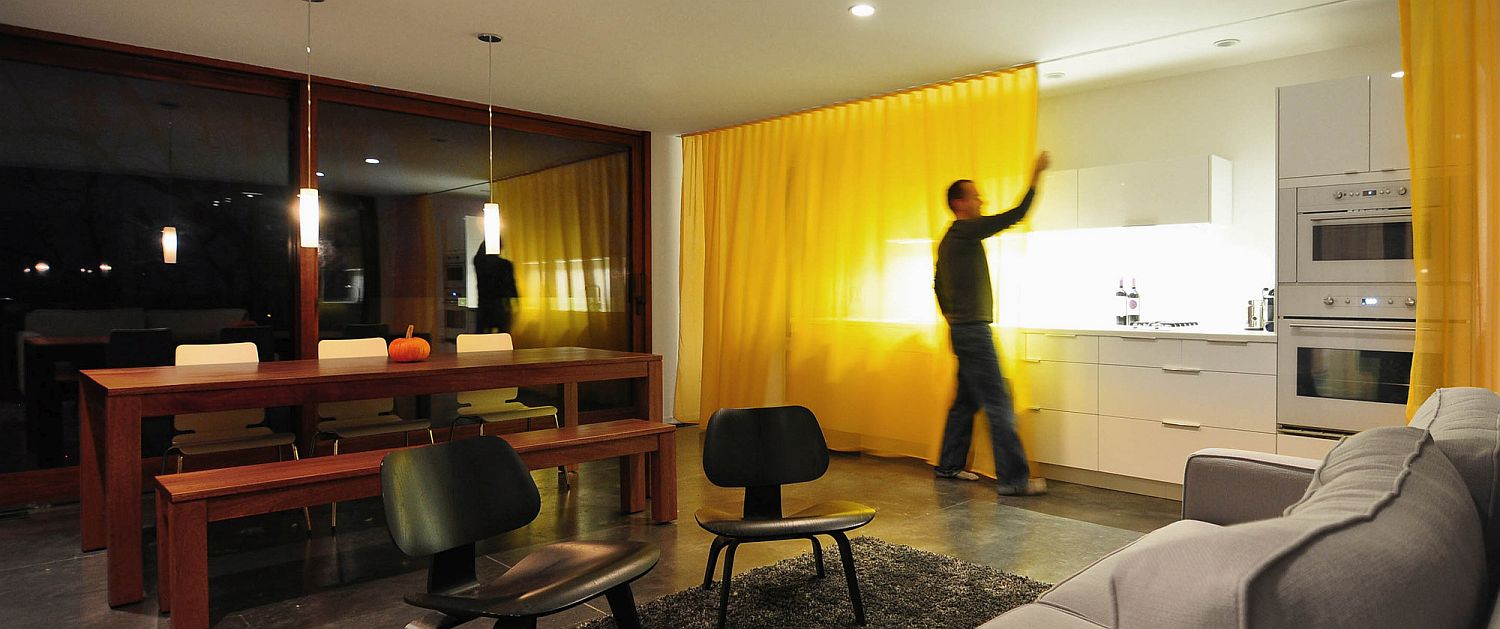 Floor-to-ceiling-drapes-on-either-side-of-the-living-area-help-in-increasing-privacy