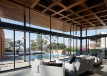 Glass-walls-and-sliding-glass-doors-connect-the-interior-with-the-pool-area-217x155