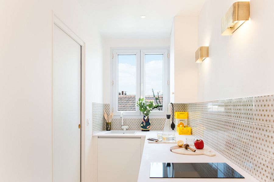 Innovative use of sconce lights in the tiny white kitchen