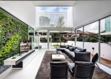 Living-room-with-green-wall-in-the-backdrop-and-ample-natural-light-217x155
