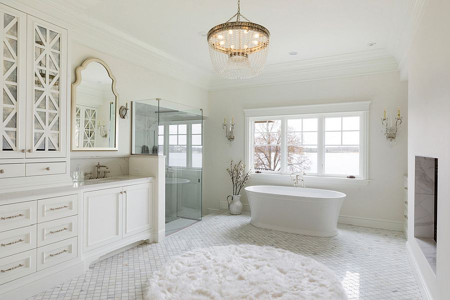 Natural lighting coupled with beautiful chandelier in the large bathroom in white