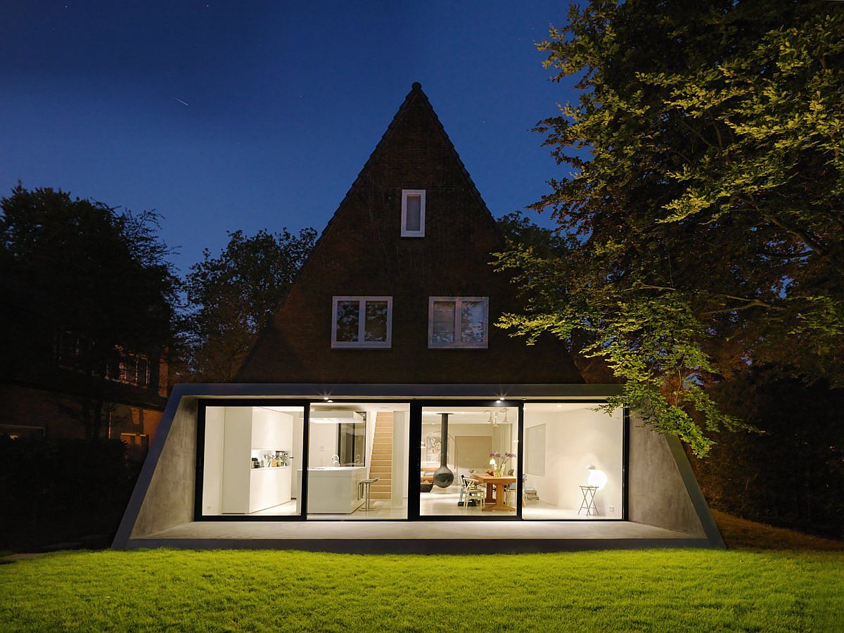 Sliding glass doors and floor-to-ceiling windows connect the open plan living area with the outdoors