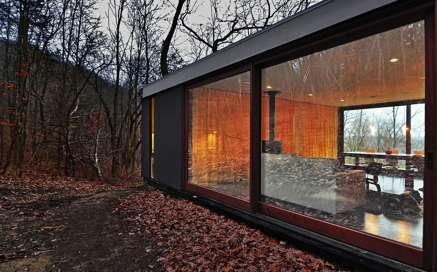 Sliding glass doors connect the interior with the landscape outside