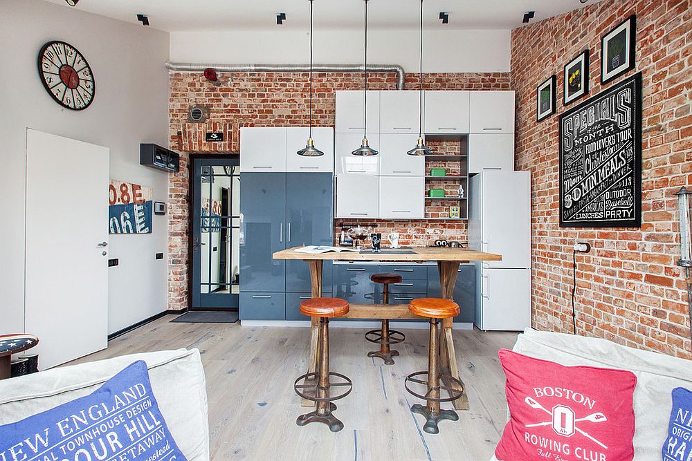 Small modern industrial kitchen with brick wall backdrop and smart pendants