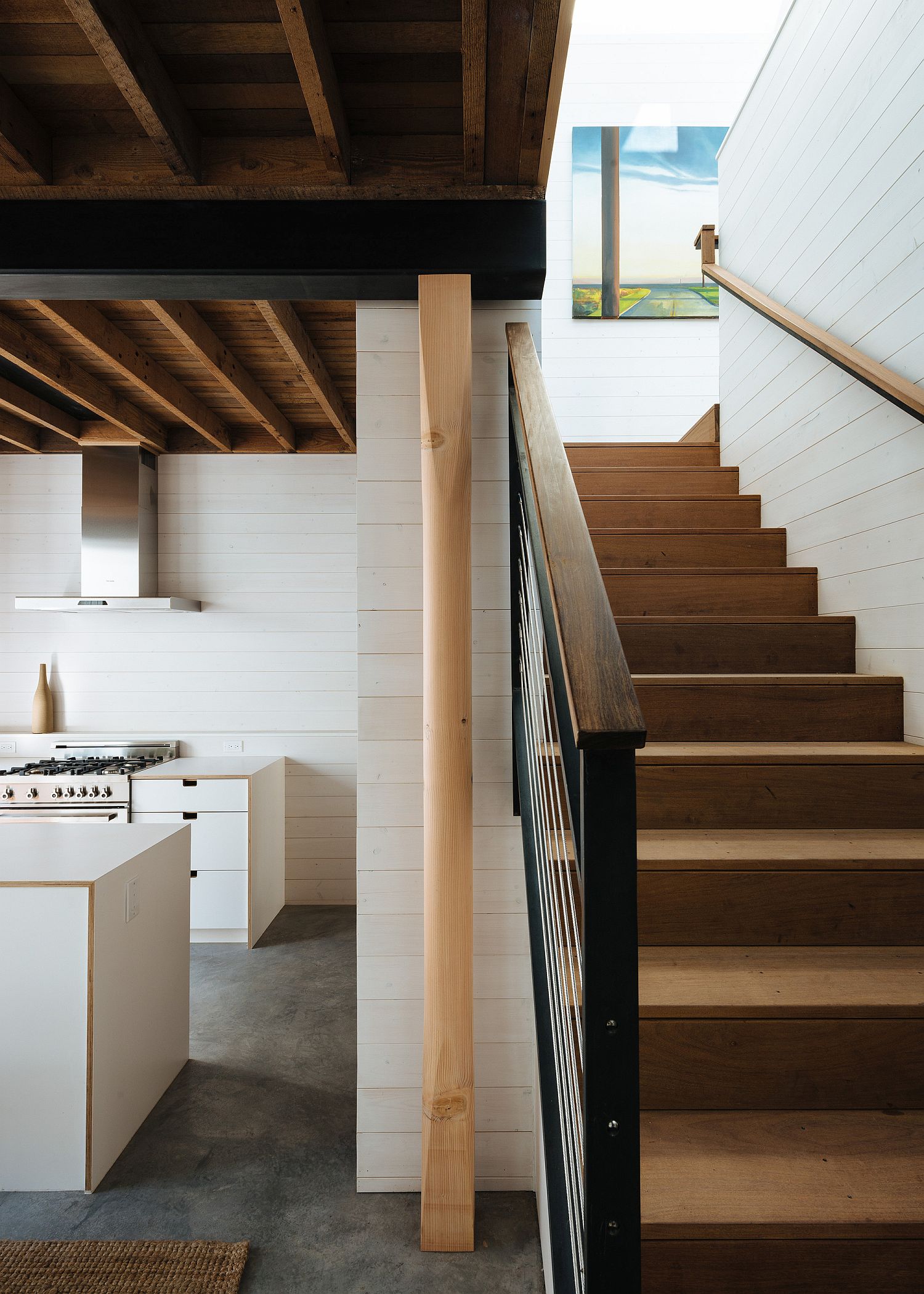 Wood, white and natural light shape the interior of the transformed house