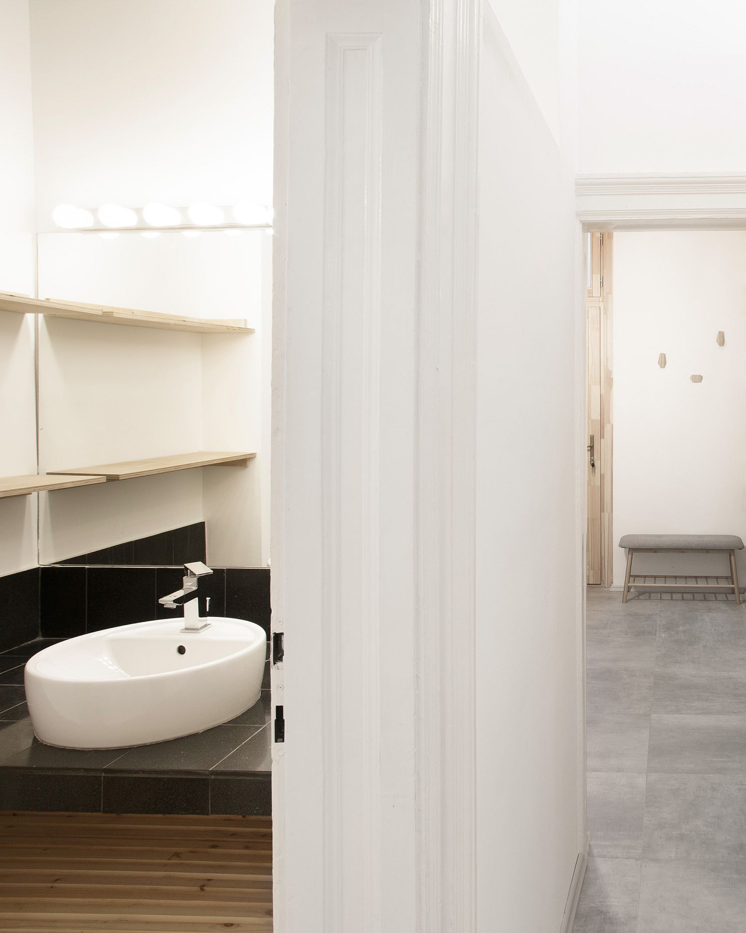 Bathroom in white with wooden vanity and stone countertop