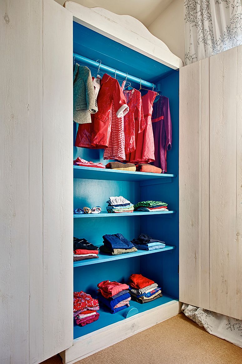 Beautiful blue closet in the bedroom adds color to a neutral setting