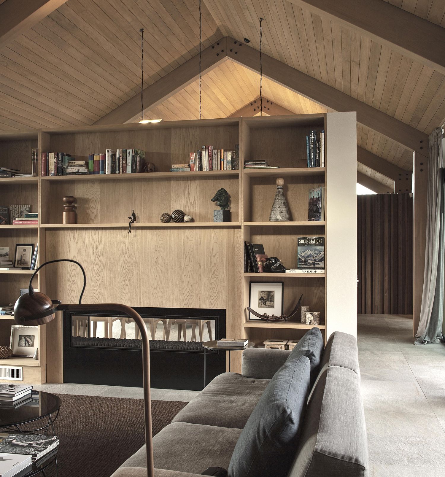 Bookshelves anchor the living room while adding color and accent features