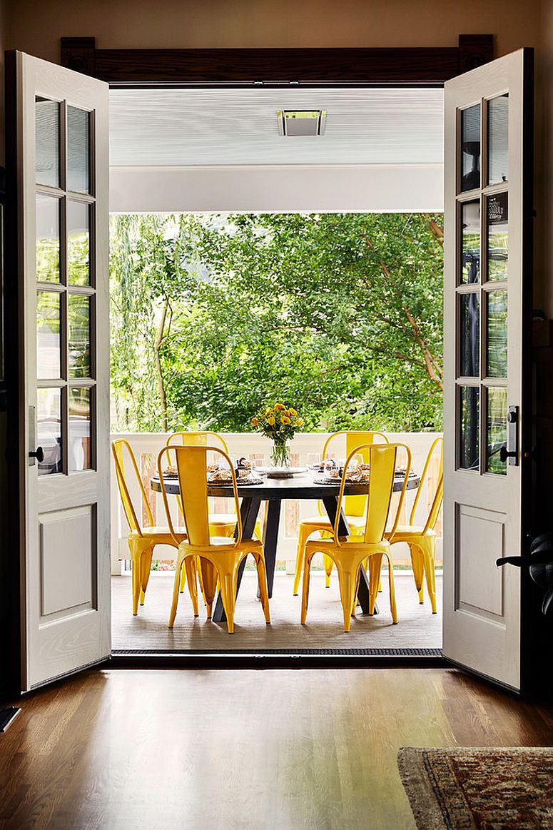 Brilliant chairs in yellow bring color to this outdoor dining space