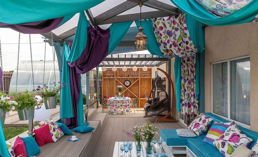 Drapes and curtains add to the color scheme of this eclectic deck