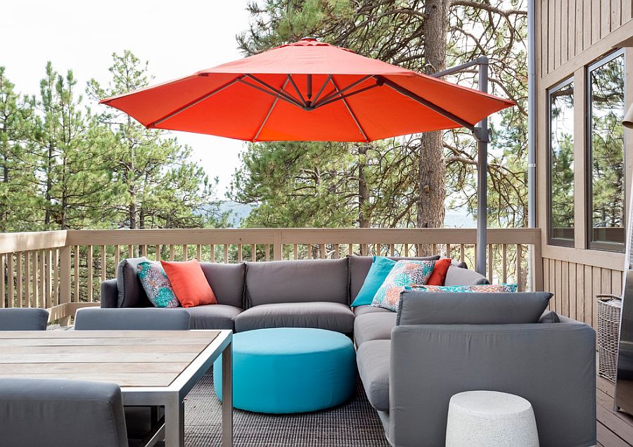 Giant-umbrella-in-orange-and-accent-pillows-in-orange-and-blue-bring-color-to-the-gray-outdoor-couch