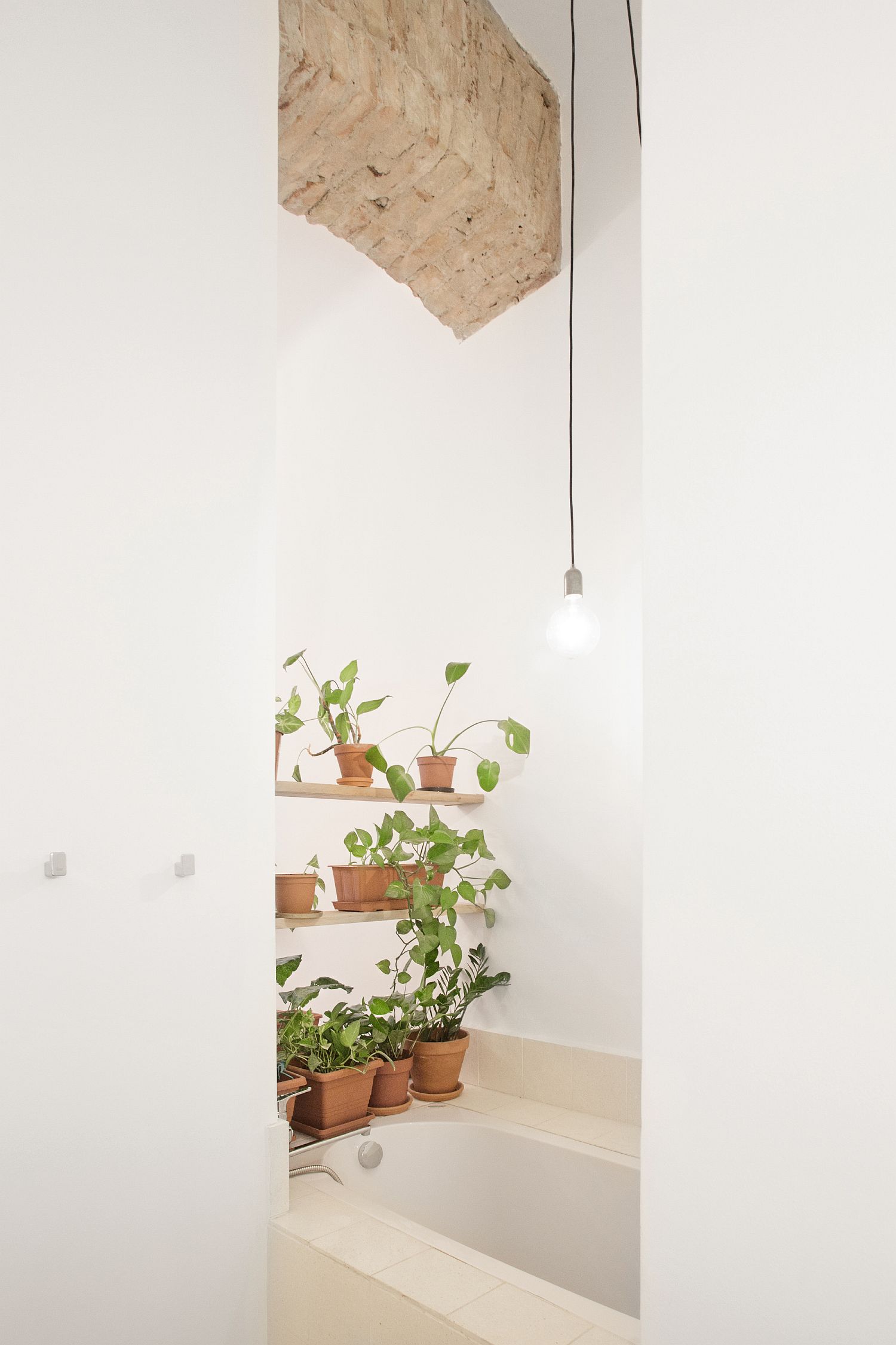 Green wall with a way to the dressing area and bathroom below