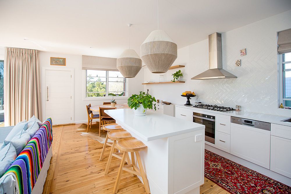 It is the rug that adds hint of color to the small kitchen in white