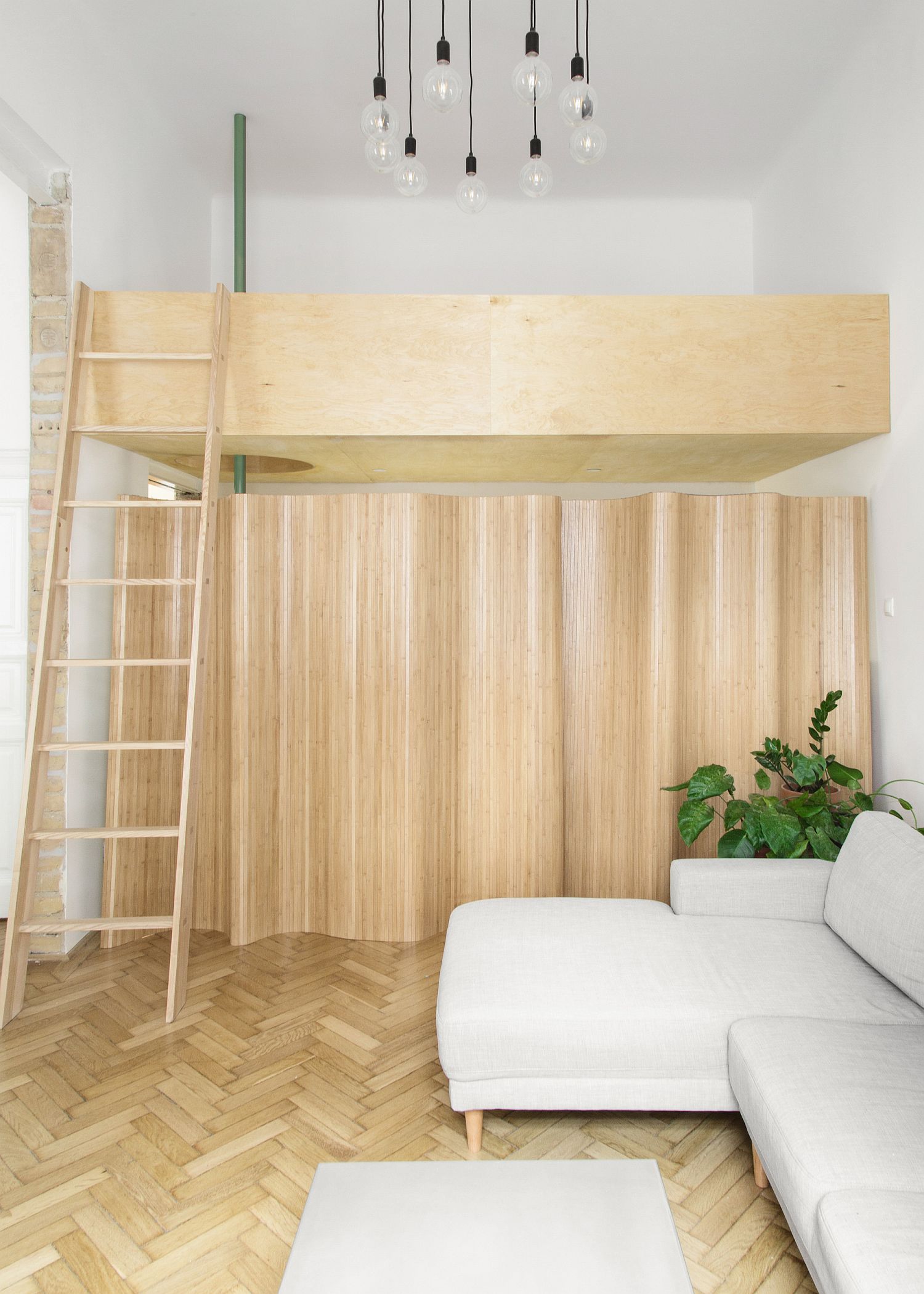 Ladders and wooden finishes give the apartment a spacious and stylish look