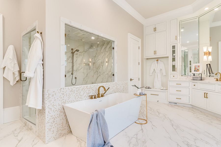 Metallic accents along with matching faucets add glitter to the white bathroom