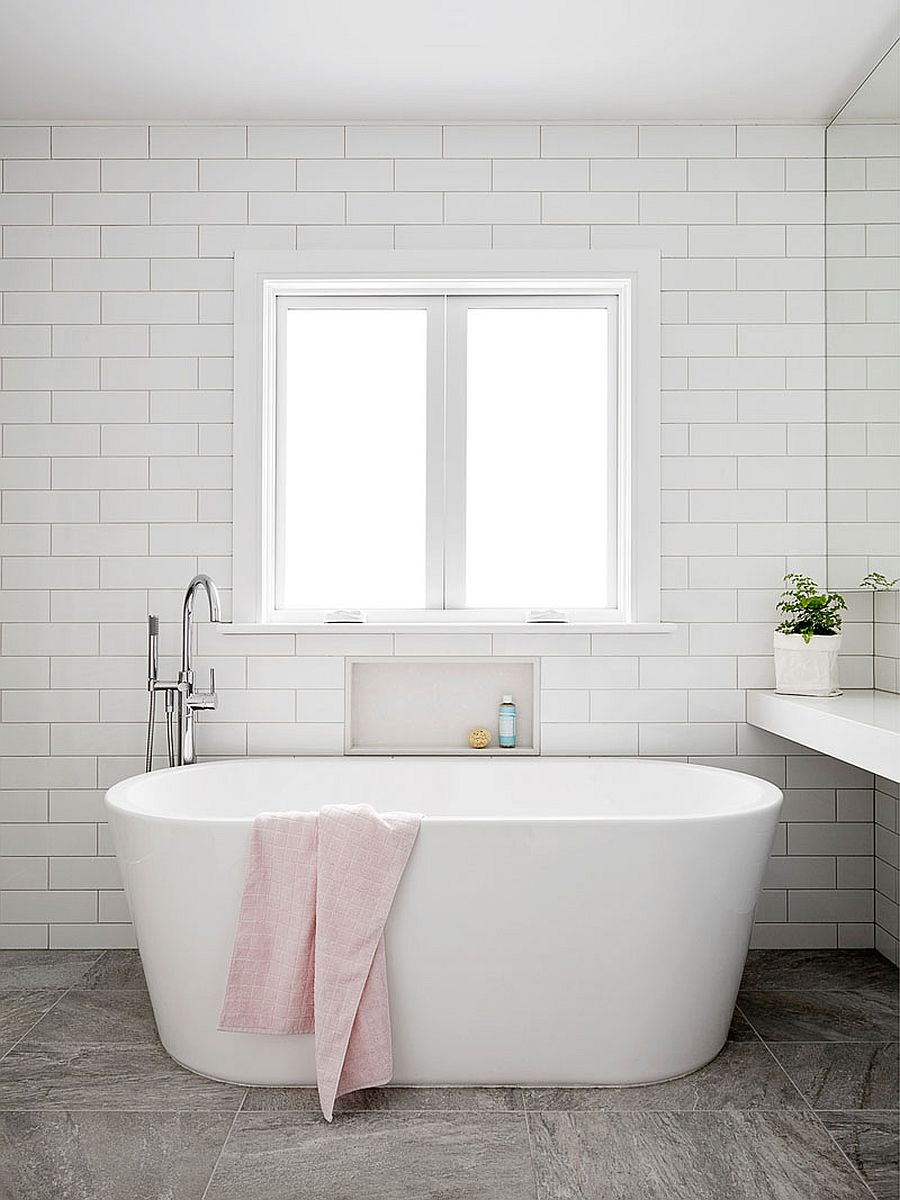 Minimal and modern bathroom of the renovated Aussie home with freestanding bathtub in white