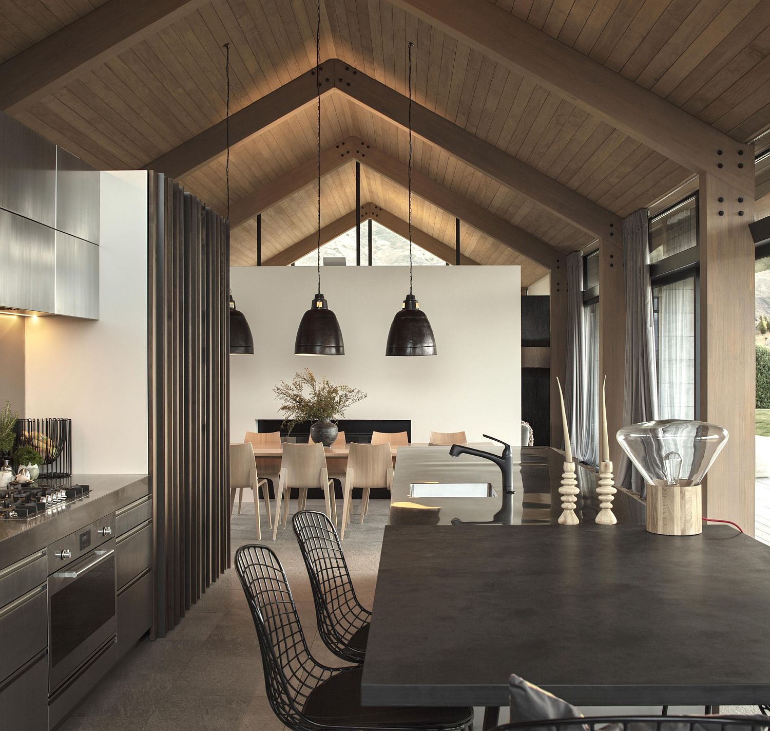 Oversized pendants in black accentuate the gabled roof of the house