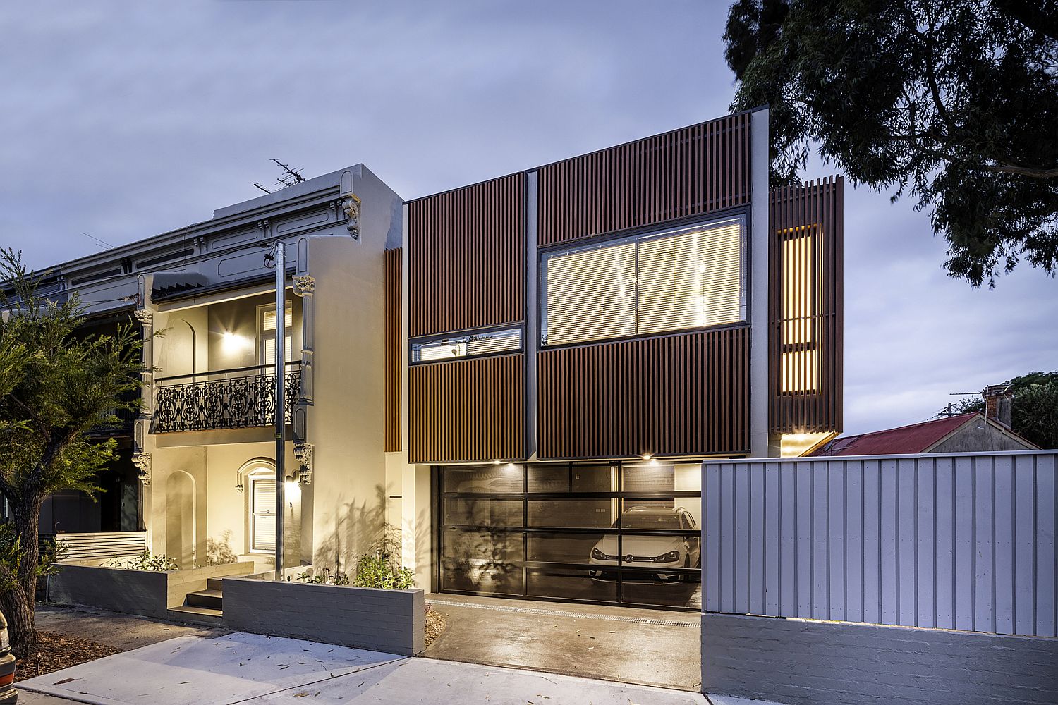 Street facade of the house after sunset