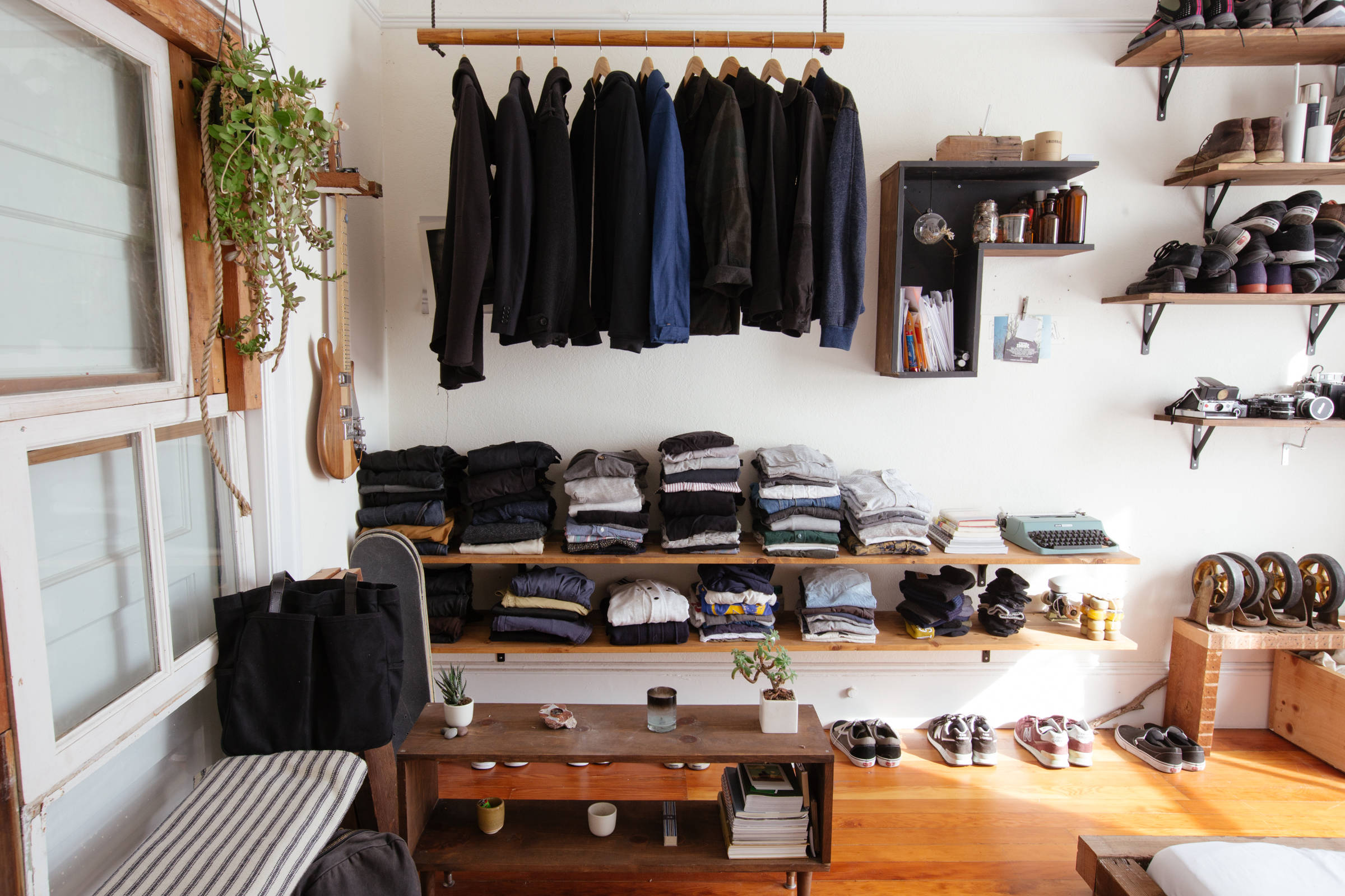 Using floating wooden shelves and wooden rods to create a closet space in the bedroom