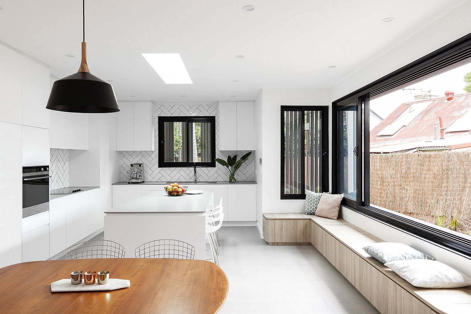 Window seat in the kitchen and dining area with storage options added to the mix