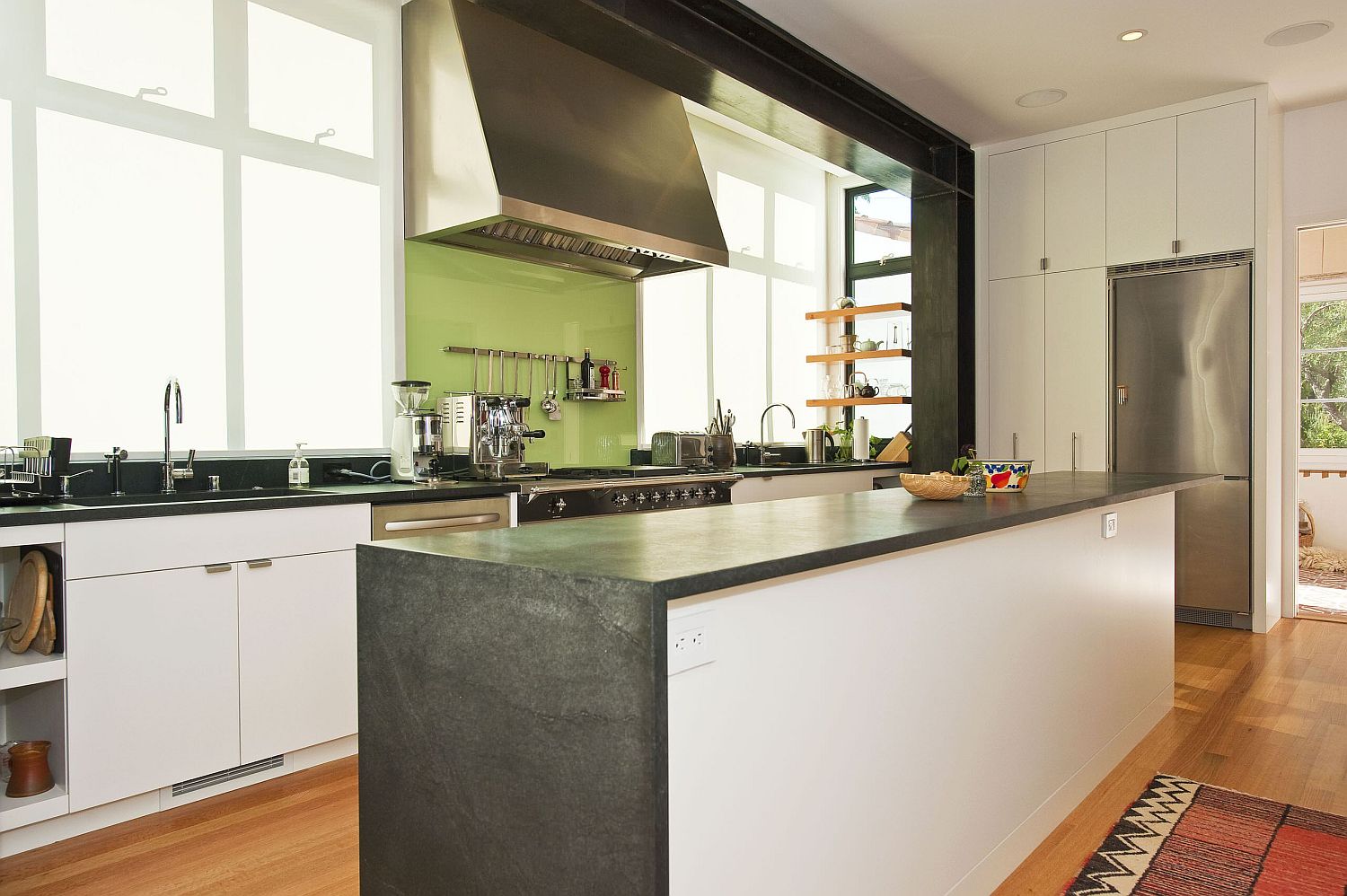 Back-painted glass backsplash in green for the modern white kitchen