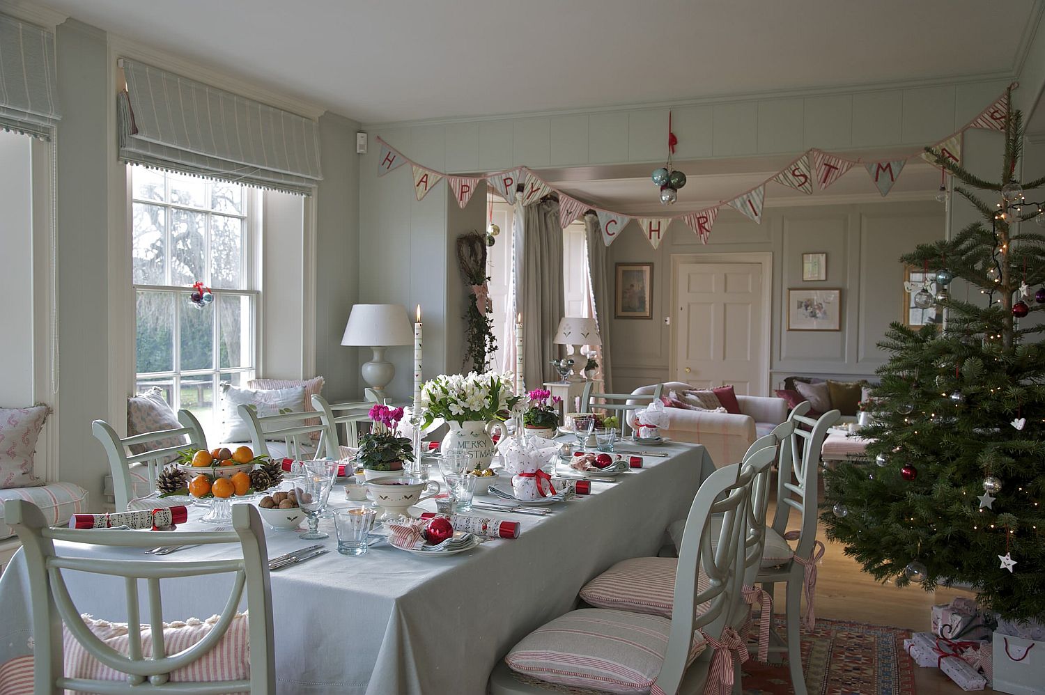 Banners, baubles and Christmas ornaments transform this farmhouse dining room into one with Holiday cheer