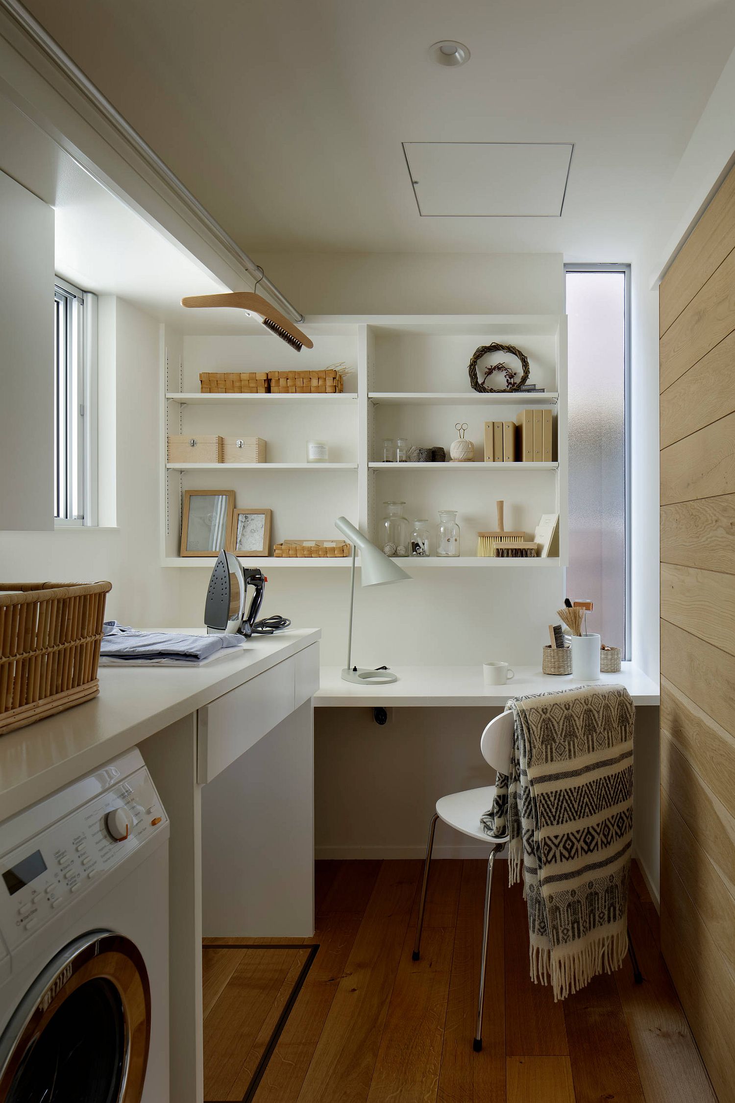 Beautiful Scandinavian style laundry room with white and wood color scheme