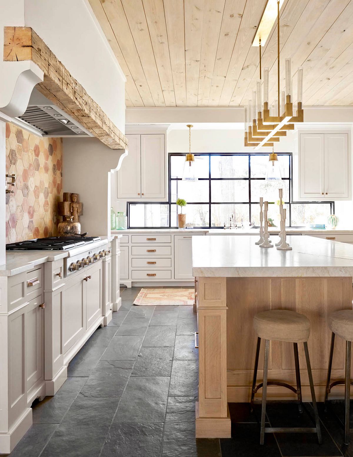 Beautiful and custom backsplash adds to the farmhouse style of the kitchen